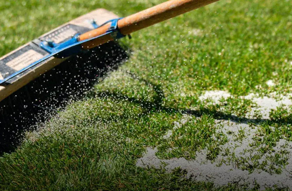 Fresh infill being applied to artificial turf during a TurFresh service