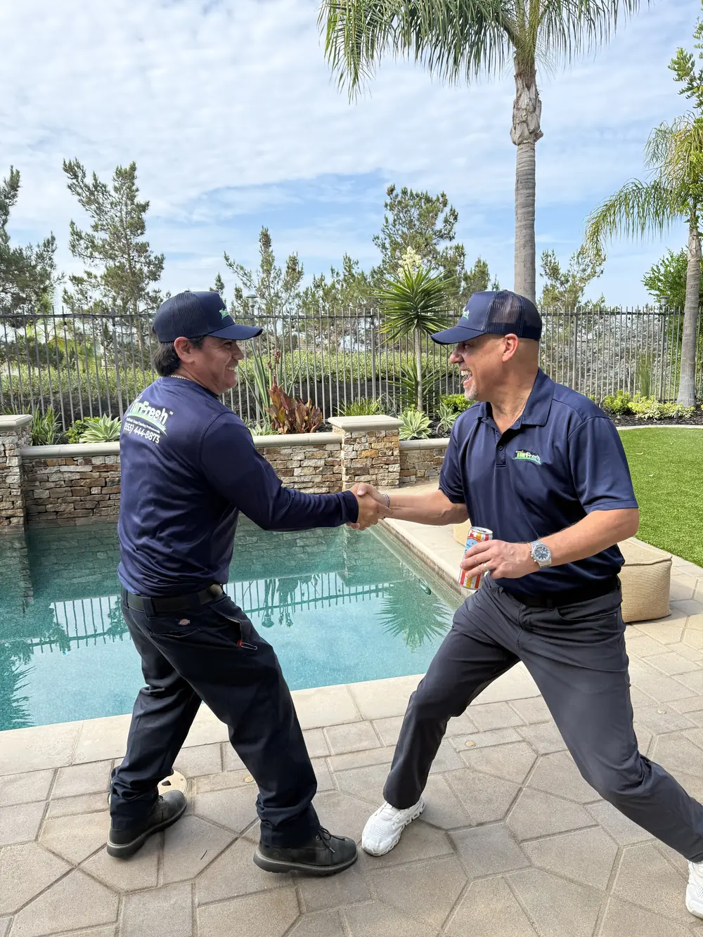 TurFresh technicians completing a customer walkthrough after a turf cleaning service