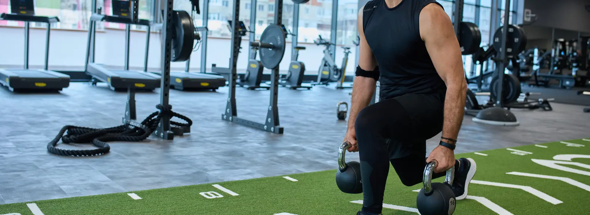 Wide view of a premium fitness facility with spotless artificial training turf