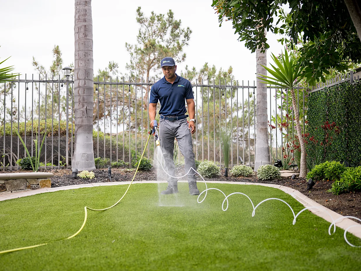 TurFresh technician applying TurFresh Treatment across artificial turf