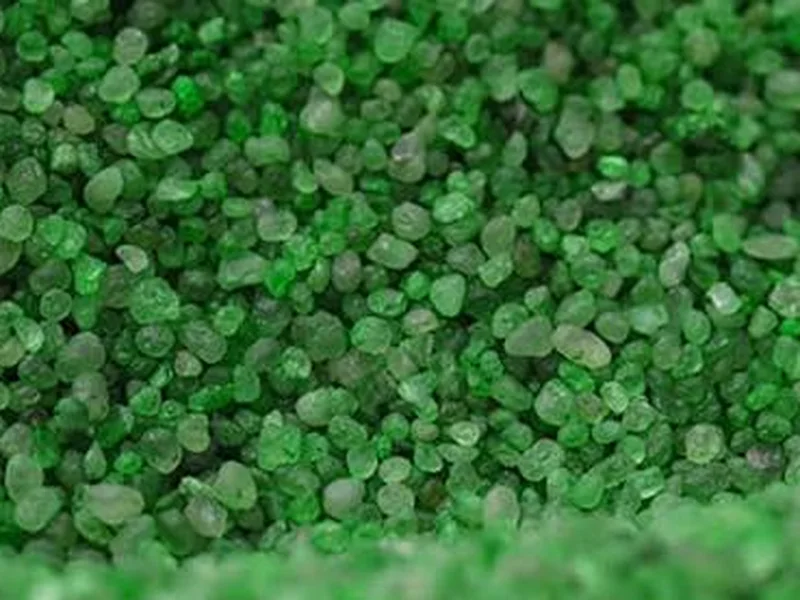 Close-up of green coated non-absorbent pet turf infill granules
