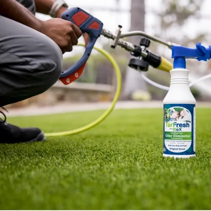 TurFresh technician spraying TurFresh Formulation onto artificial turf