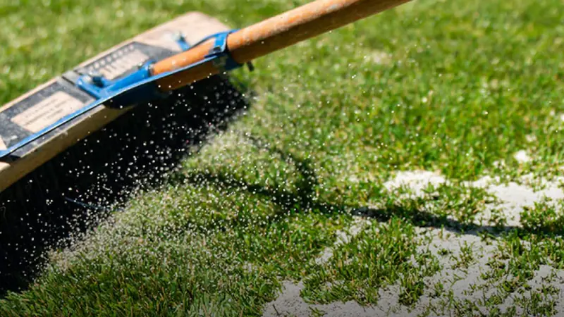 Fresh TurFill infill brushed into clean artificial turf fibers
