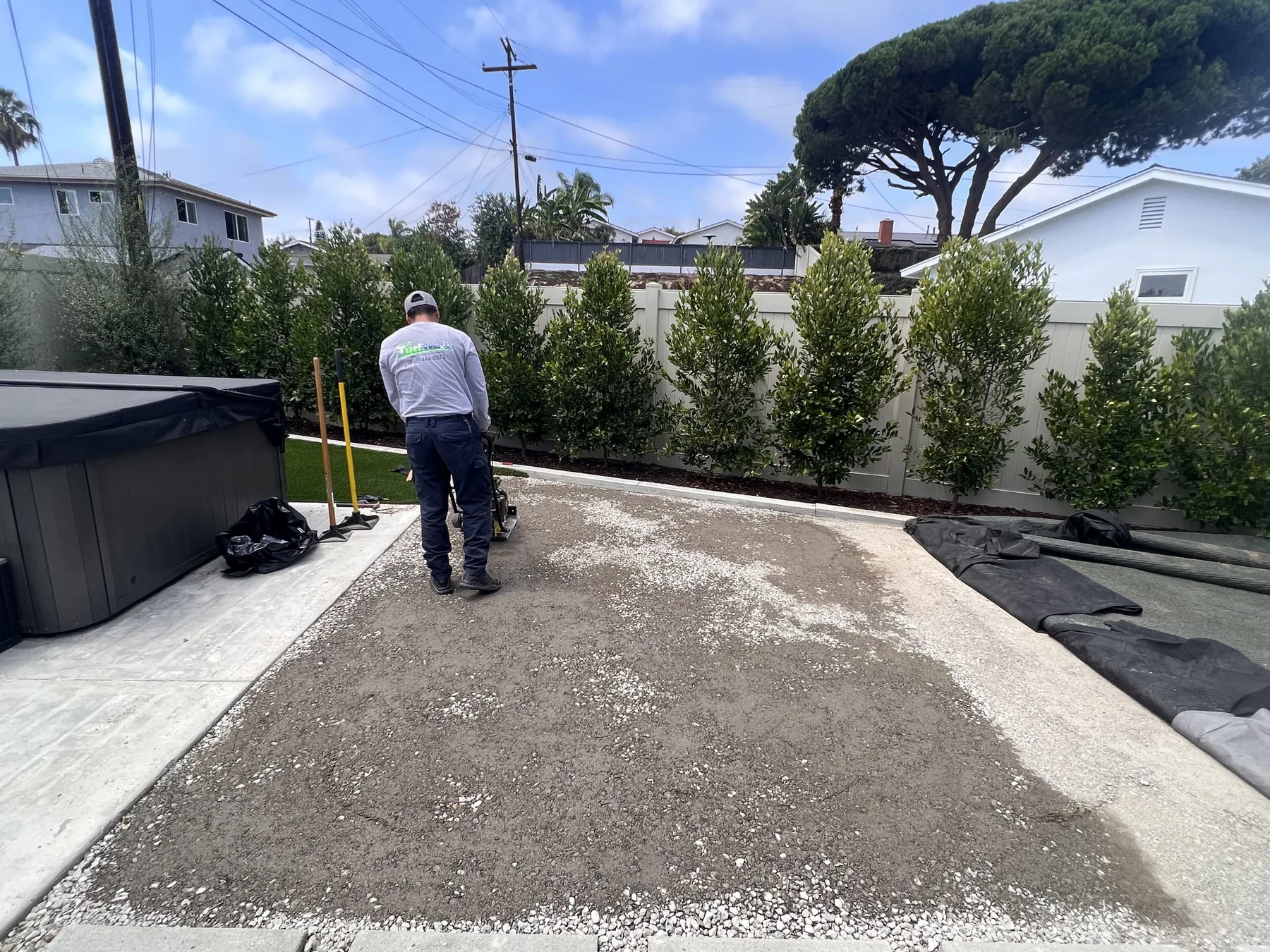 TurFix technician compacting the decomposed granite base during an artificial turf repair