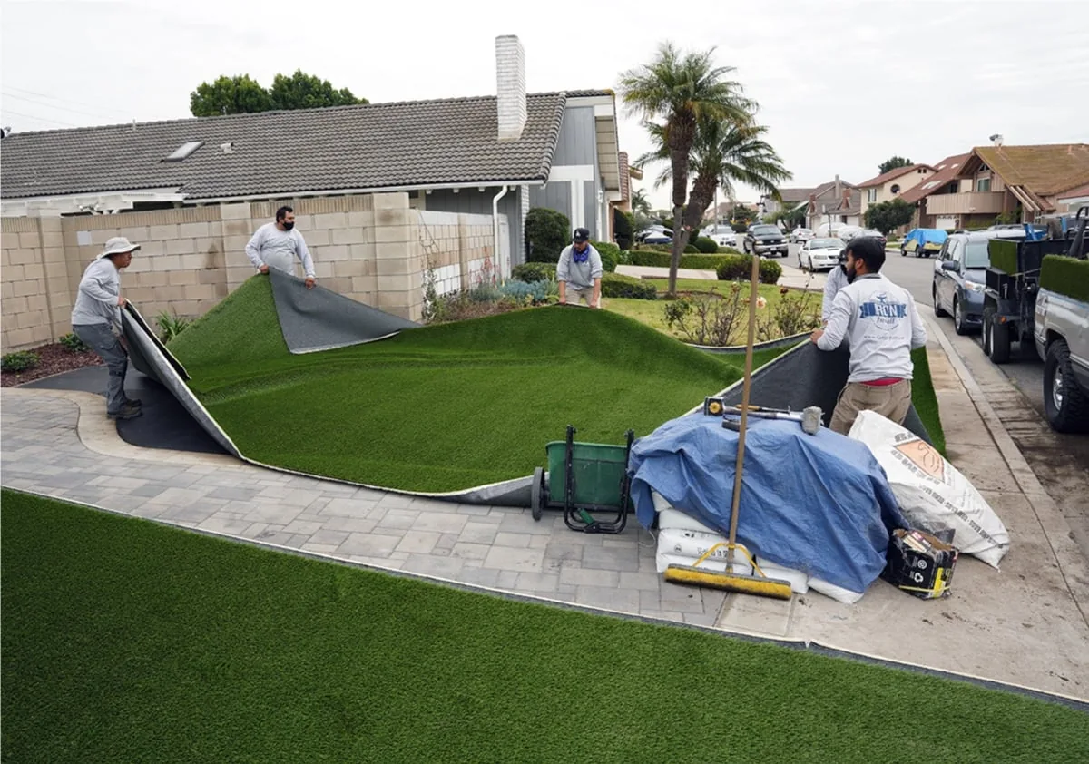 TurFresh TurfSwap crew positioning new artificial turf during a full front yard replacement