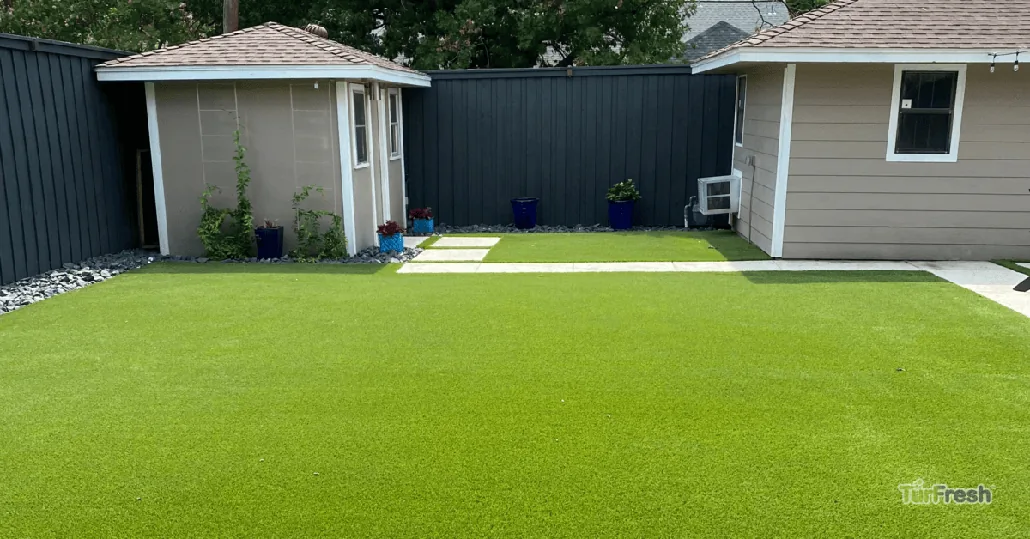 Well-maintained artificial turf lawn in front of a home for sale after professional TurfBloom reblooming service