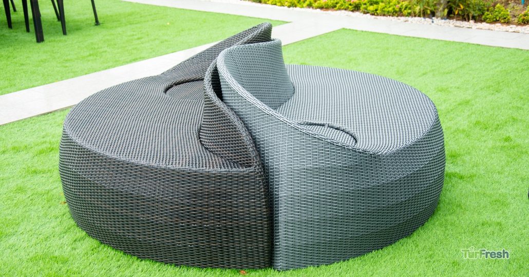 Outdoor wicker furniture on bright artificial turf professionally cleaned by TurFresh.