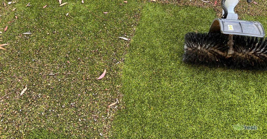Artificial turf covered in debris on the left side, with freshly cleaned turf on the right after TurFresh grooming.