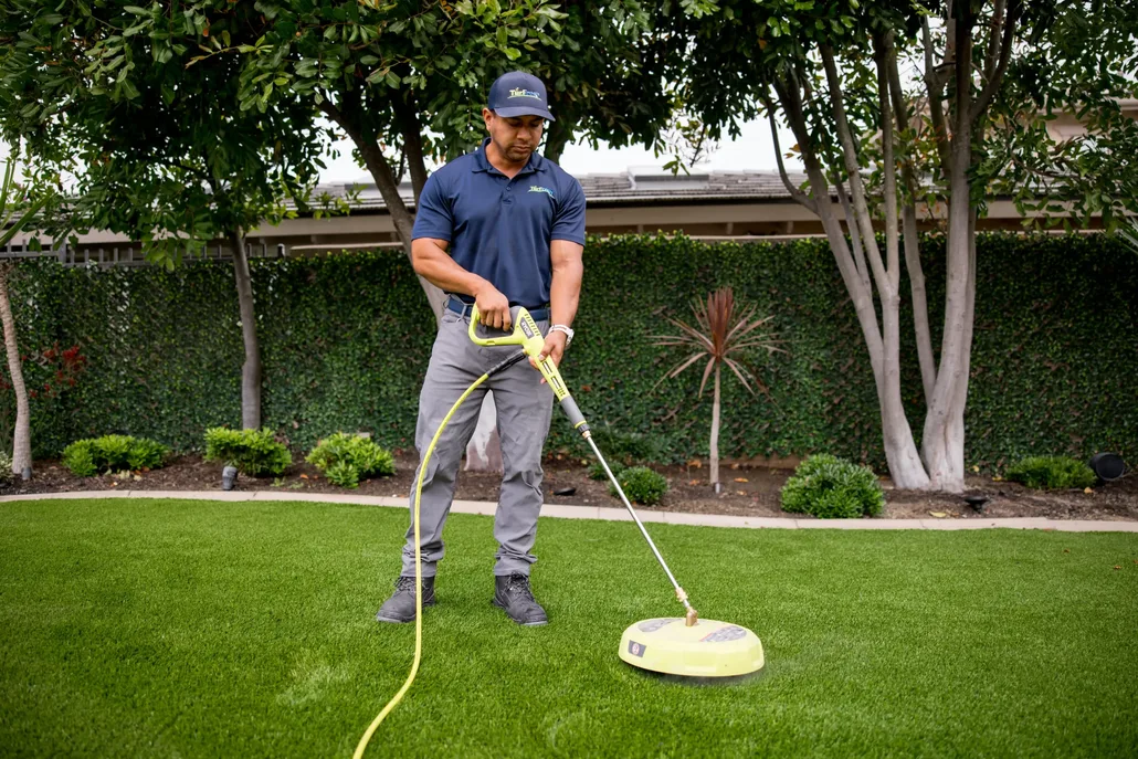 TurFresh team performing professional artificial turf deep cleaning service with specialized extraction equipment